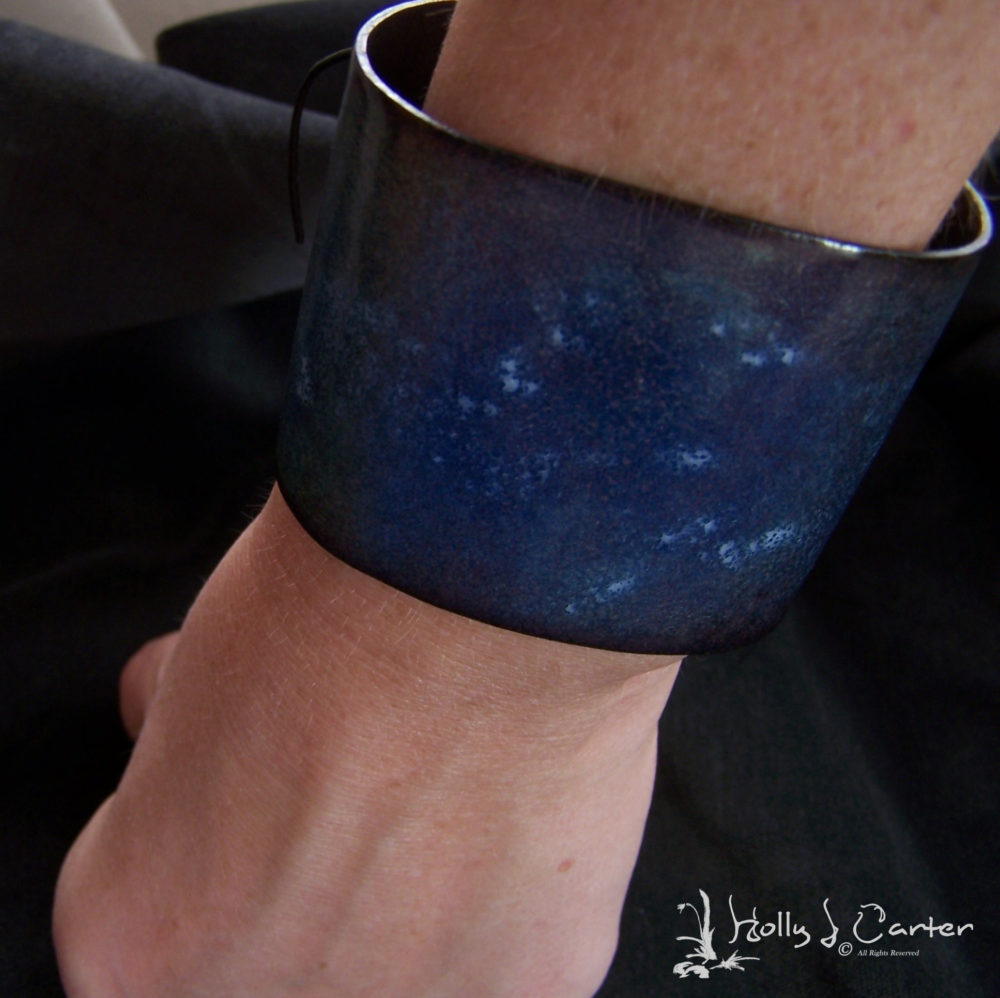 This Cuff is Quite Unique and one-of-a-kind, handmade by artist Holly J Carter. It is Copper with Vitreous Glass Enamel and Laces up with Black Leather.