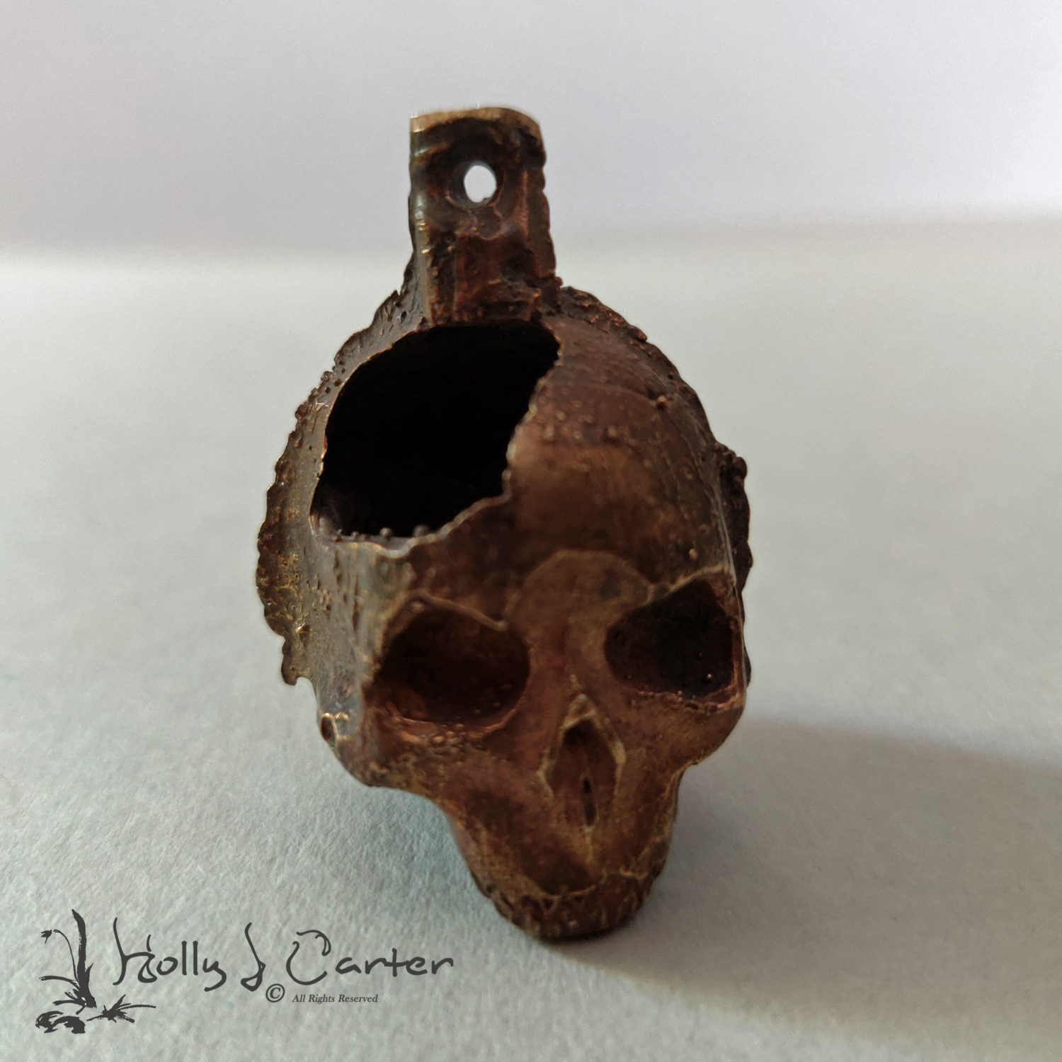 Skull handcrafted by metals artist Holly J Carter. Bronze with an aged finish. Great Halloween, Dia de los Muertos, Biker, or Goth Pendant, Key Chain Fob, or Charm.